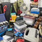 Hoarder home packed with stored boxes, vintage electronics, files, business equipment and household items.