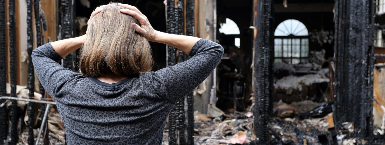 Fire Damage Restoration - Woman Stressed after her home has burned down