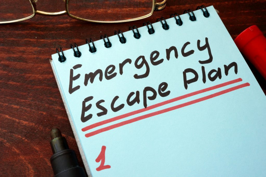 Emergency Escape Plan written on a notepad with marker.