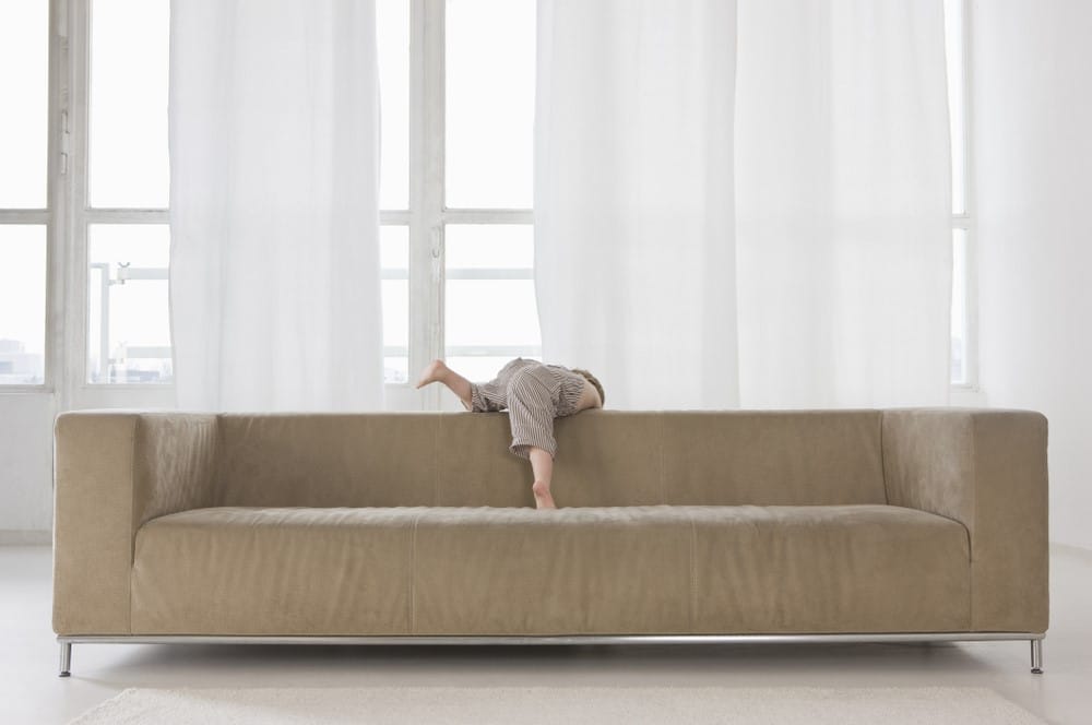 Child Hanging Off Back of Couch