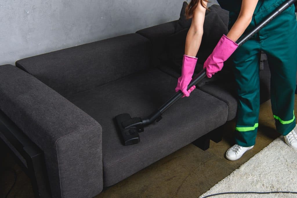 woman cleaning a couch
