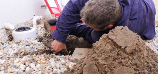 Plumber fixing an underground hot water pipe leaking with a tools