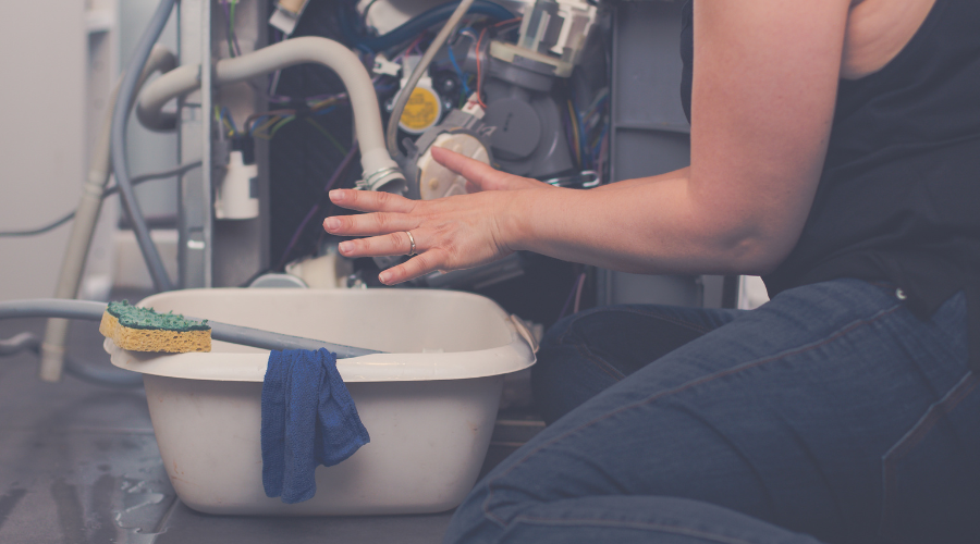 Woman tries to repair dishwasher leak