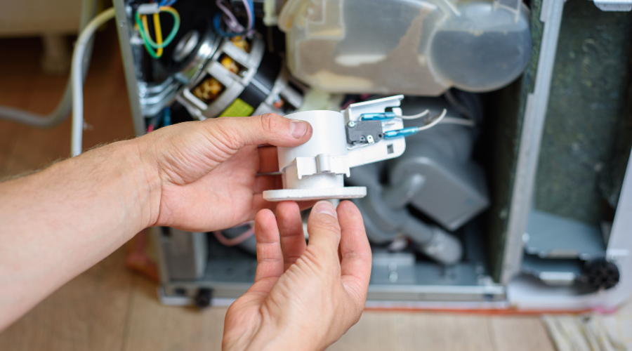 handyman repairs dishwasher. water leakage protection