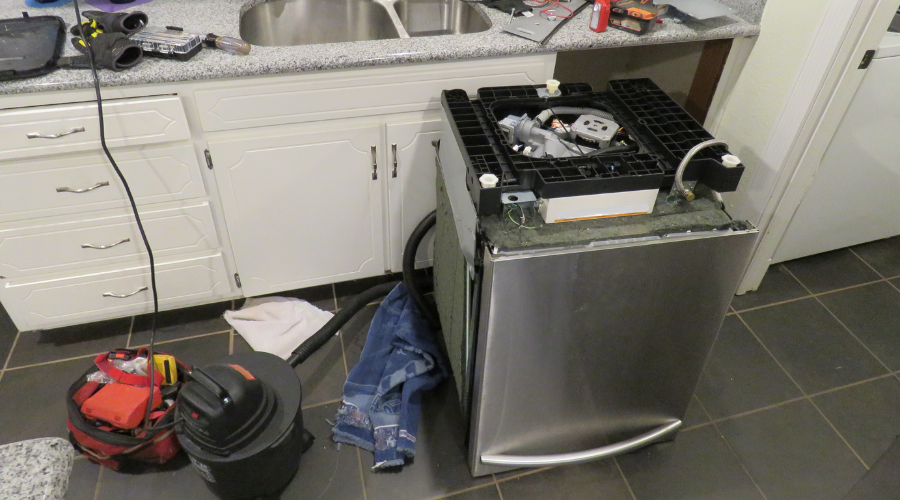 kitchen dishwasher being repaired