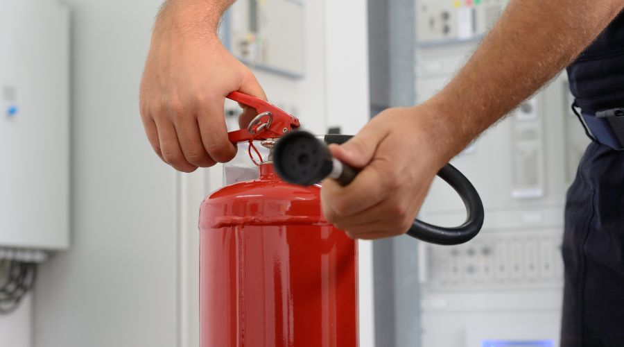 man showing how to use fire extinguisher